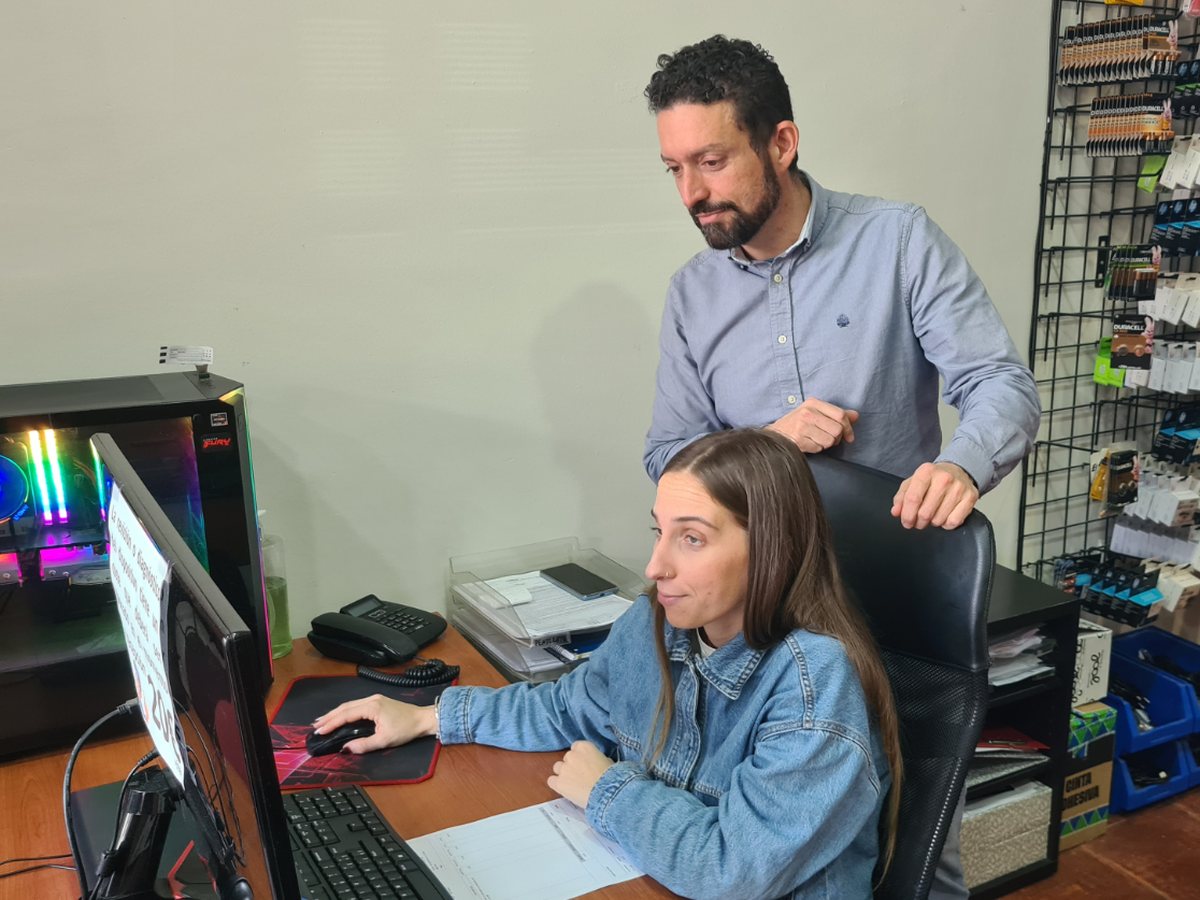 Fernando Medina y una compañera revisando juntos una pantalla en el mostrador de MR Micro Informática.